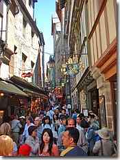 Narrow medieval bustling streets in Mont St Michel