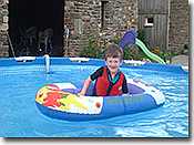 Child in boat enjoying the large 15 foot swimming pool